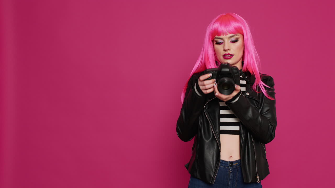 Young beautiful woman working with dslr camera as photographer