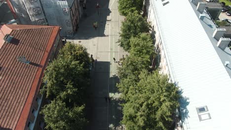 aerial drone shot of city main road ascending and revealing city with forest on the hill view. in europe