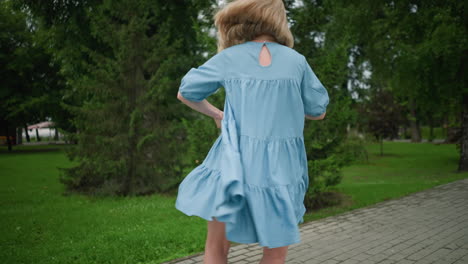 a mother spins her son around playfully while her gown floats in the wind