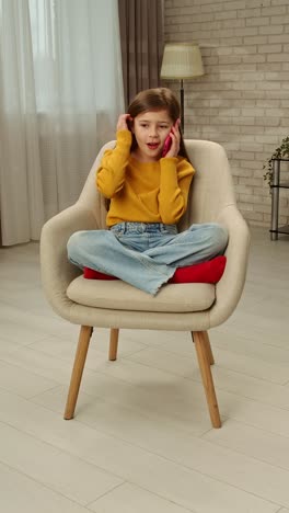 girl talking on a phone in a chair