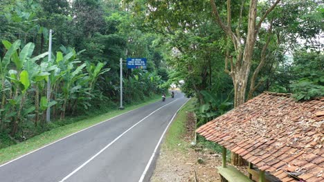 scenic mountain road with tropical vegetation and motorbikes