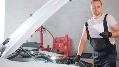 mechanic working on a car engine in a garage