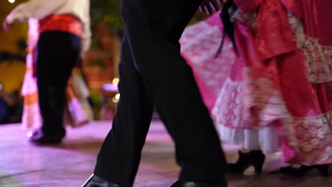 Mexican-men-and-women-dance-together-on-a-stage