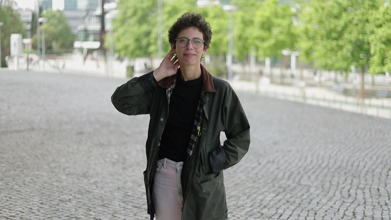 Woman standing on street and smiling at camera