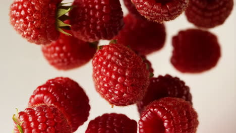 falling fresh red raspberries