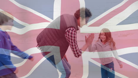 union jack flag animation over man and girl walking on beach