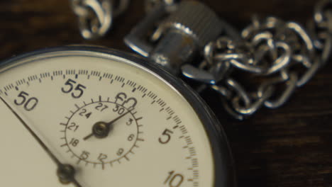 stopwatch on a dark wooden tabl