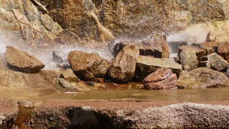hermosa cascada desde un acantilado en el bosque. 4k video de agua que fluye, arroyo que fluye entre las piedras. arroyo en el bosque