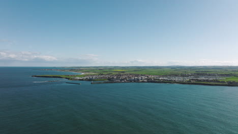 4k aerial of seahouses harbour, united kingdom on a sunny afternoon