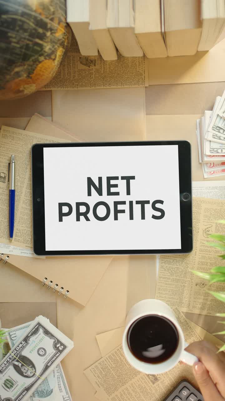 VERTICAL VIDEO OF NET PROFITS DISPLAYING ON FINANCE TABLET SCREEN