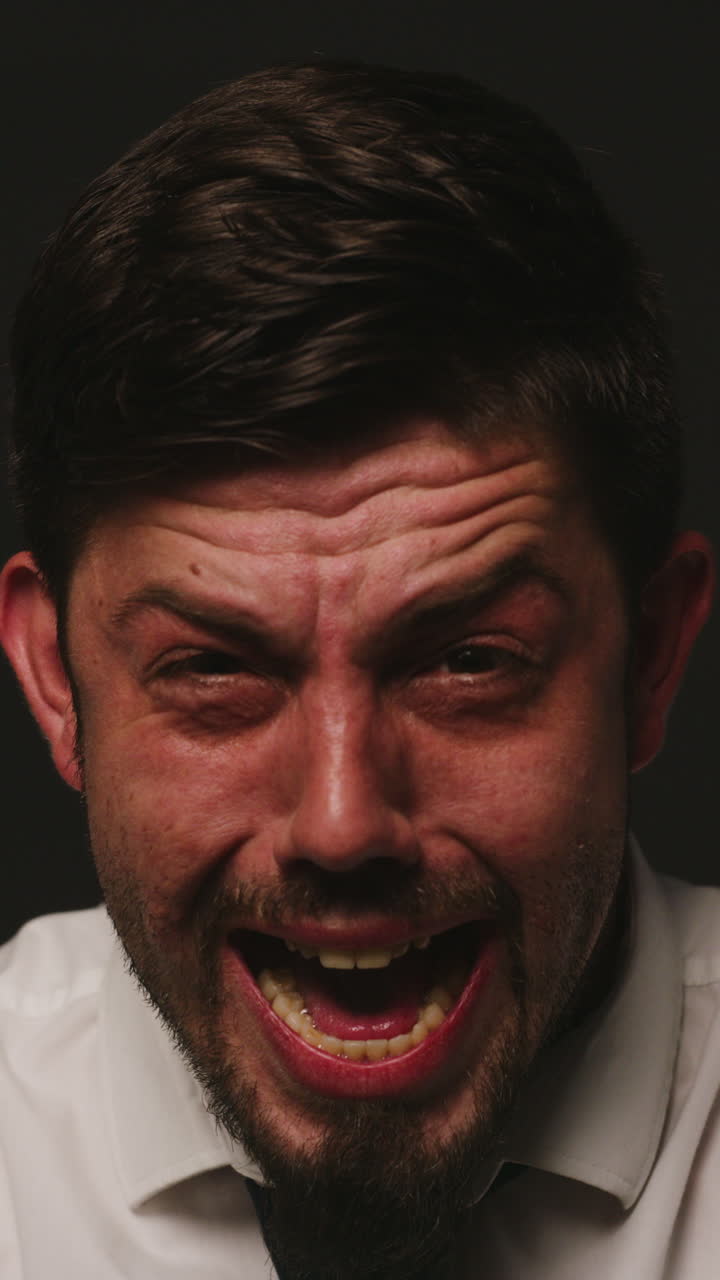 Man's Face Showing Changing Emotions from Serious to Laughing to Angry