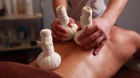 back massage with herbal balls