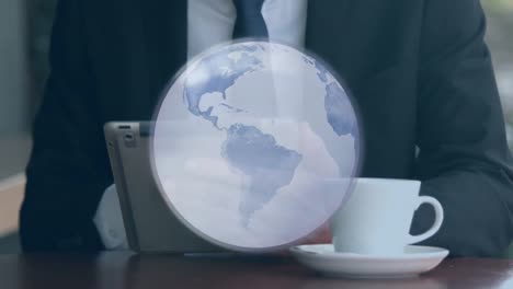 animation of grey globe over businessman with coffee using tablet