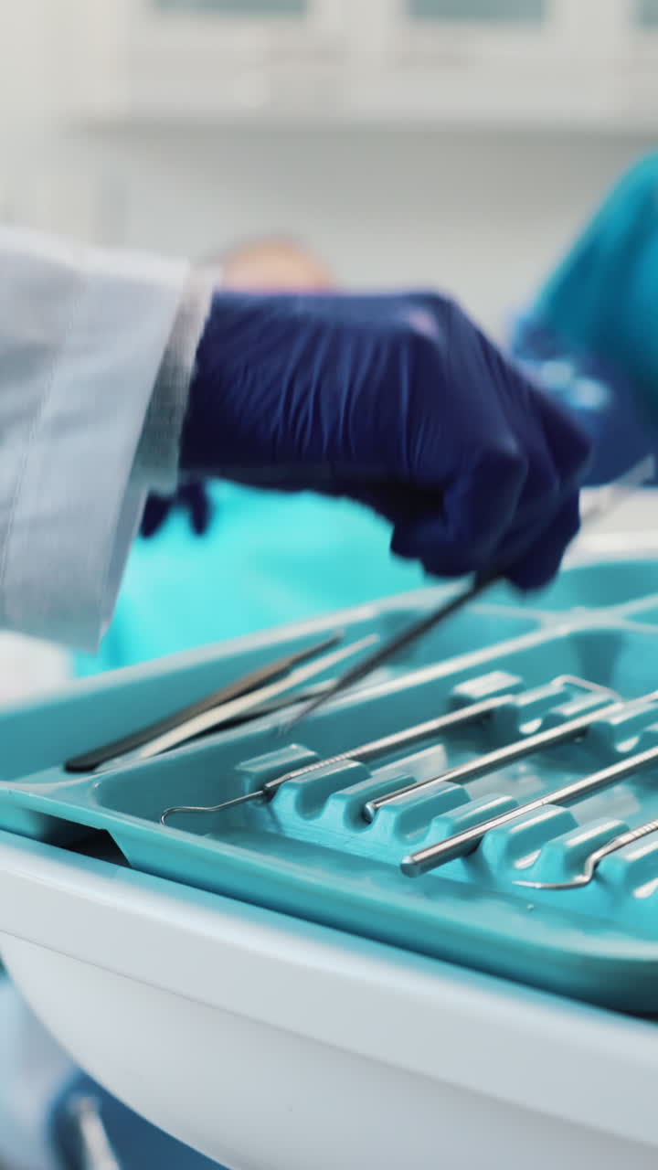 Dentist's Hand Selecting Tools for Child Patient