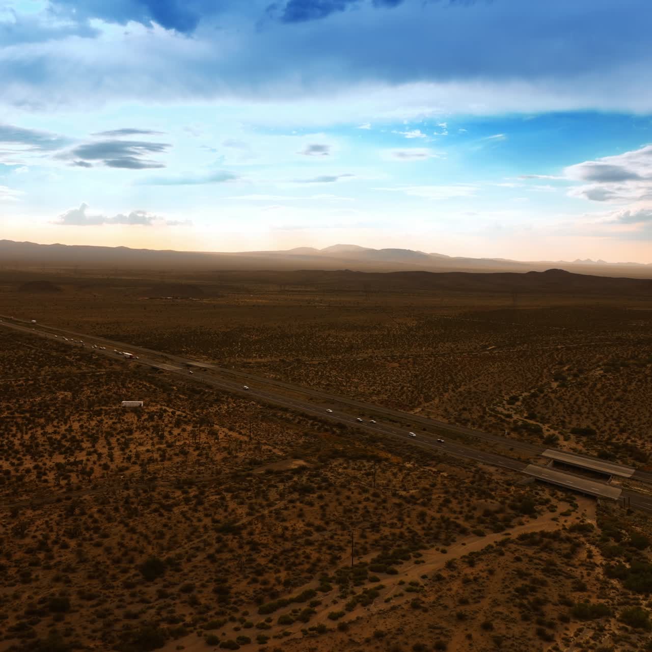 Traffic on the highways of Nevada valley. Transport moving by the roads in the dry desert. Aerial view