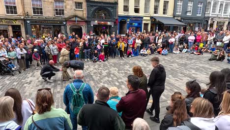 crowd watching performers in edinburgh's historic streets