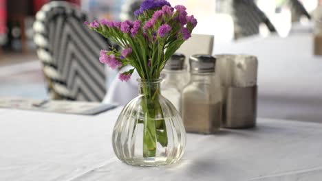 flowers in a vase on a restaurant table