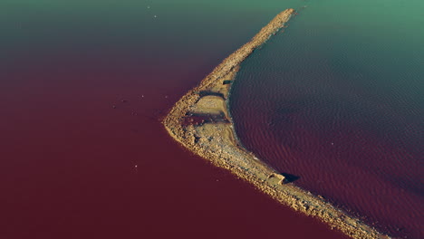 aerial view romantic island at pink sea surface. colourful sea water surface