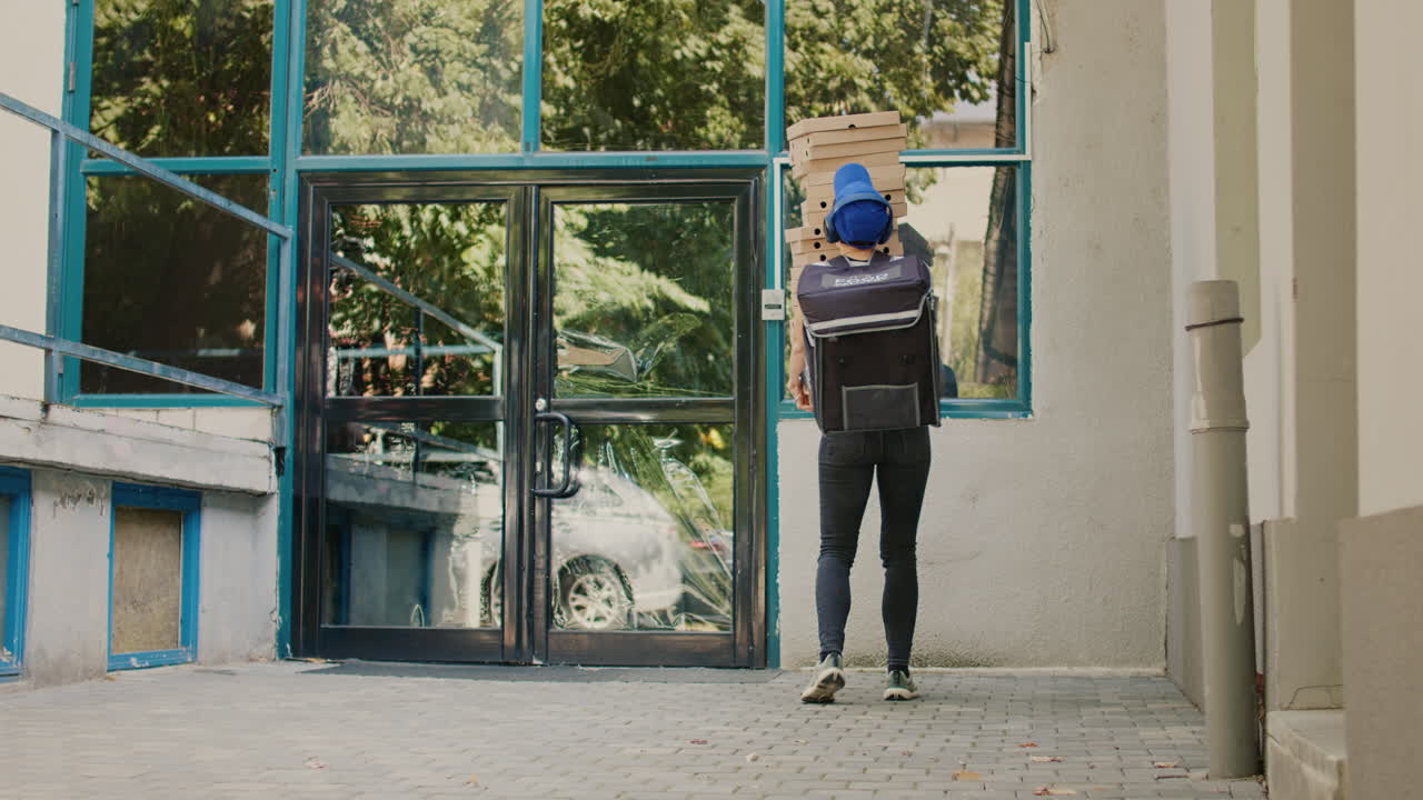 Pizza Delivery Person Carrying Stack of Boxes