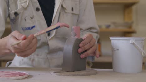 young female potter working in her studio