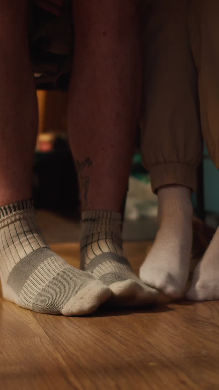 Close-up of two people's feet wearing socks