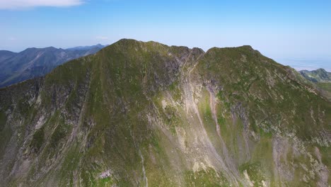 Aerial-shot-of-Moldoveanu-and-Vistea-Mare,-the-highest-peaks-in-Romania's-Fagaras-range,-in-bright-daylight