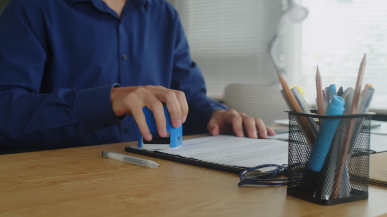 Businessman Signing and Stamping Contract at Office Table