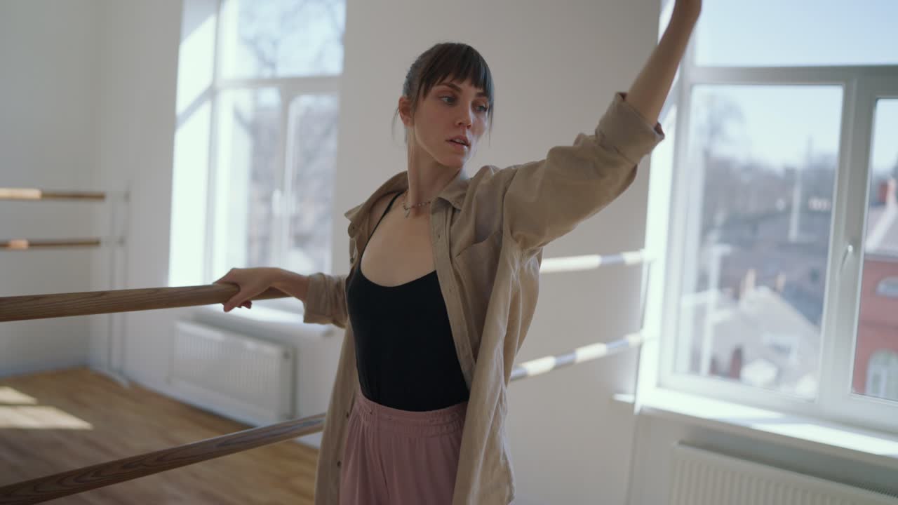 Ballet dancer practices at the barre