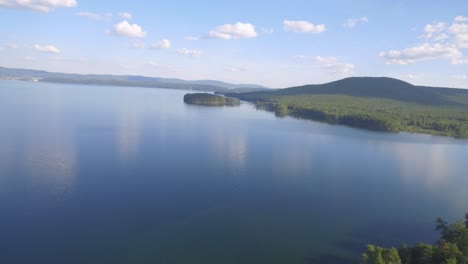 aerial view of a serene lake and surrounding forest