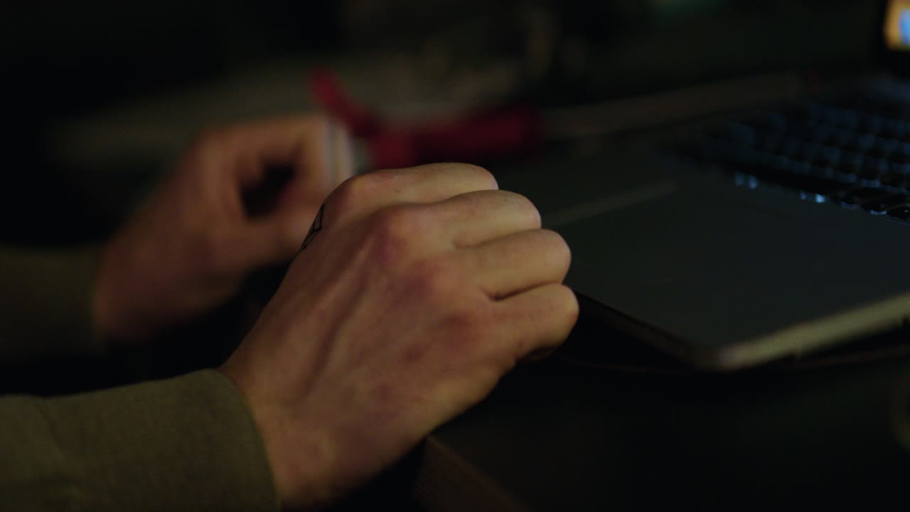 Person Typing on a Laptop at Night