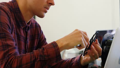 mechanic checking diameter of chain ring with vernier calipers 4k