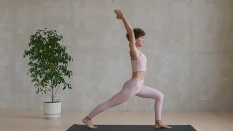 woman practicing yoga warrior pose