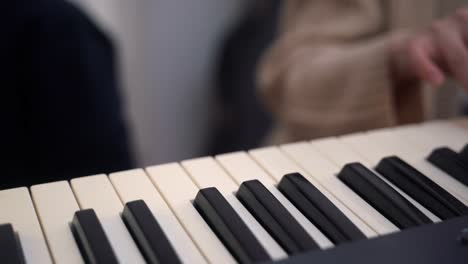 woman playing synthesizer and creating song