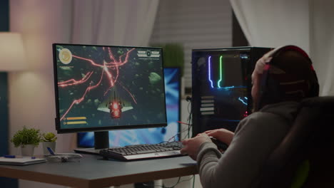 Focused-pro-cyber-keeping-hands-on-head-after-losing-space-shooter-video-game