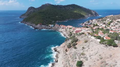 coastal village in greece with dramatic cliffs and a picturesque bay