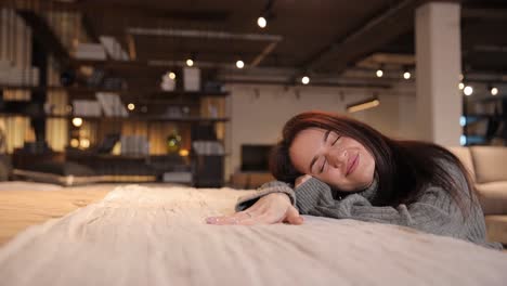 selection of upholstered furniture in a furniture salon a woman is considering buying a bed selection of upholstered furniture in a furniture salon a woman is considering buying a bed for comfort and softness the choice of comfortable furniture for life