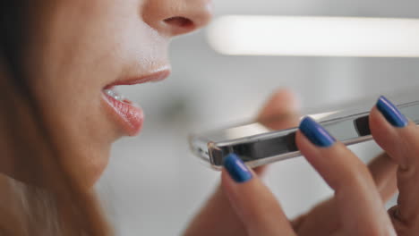 woman mouth talking smartphone speaker closeup. girl recording voice message