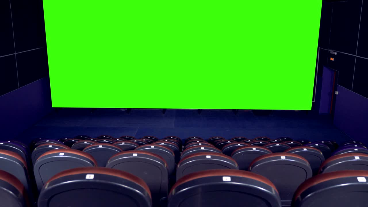 Blank movie theater screen with green screen background in empty cinema hall.