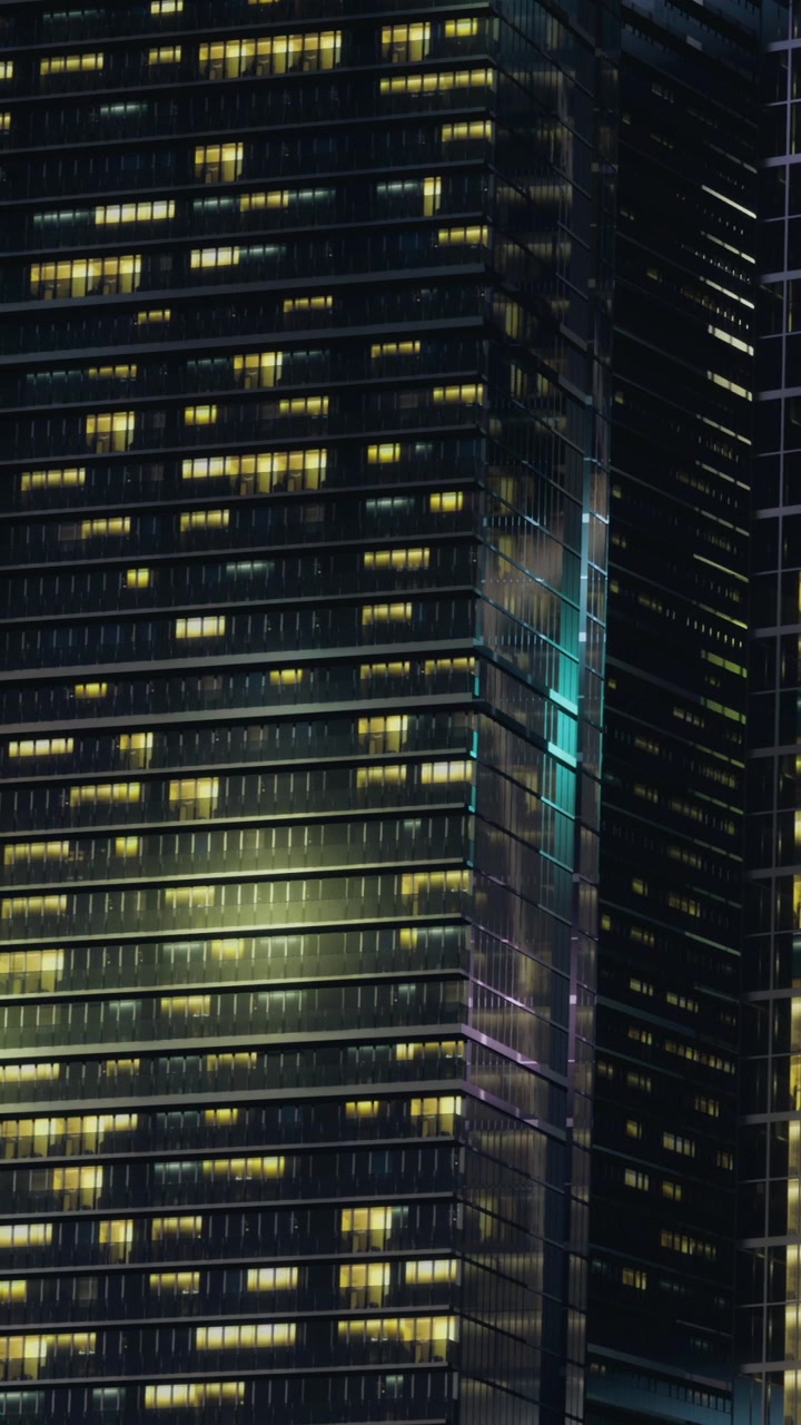 City skyline shows tall buildings with lights at night in urban area