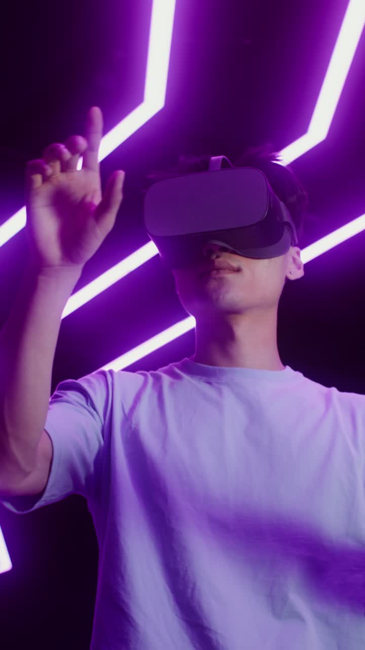 Man using VR headset in neon-lit environment