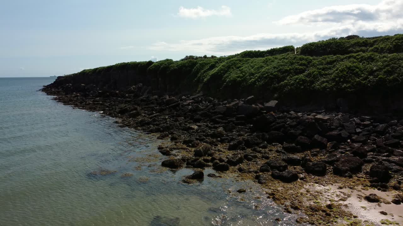 vista aérea traeth lligwy jurásico rocoso erosionado ángulos escarpados costa costera, lento empuje en