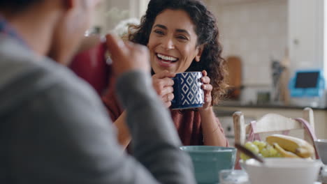 beautiful-happy-woman-drinking-coffee-chatting-to-husband-at-home-enjoying-conversation-in-kitchen-at-breakfast