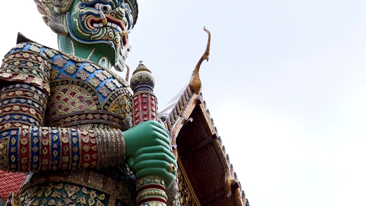 Close-up views of a vibrant, ornate guardian statue with intricate patterns and vivid colors.