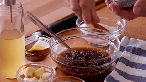 marinade preparing, sprinkling dry herbs and apple vinegar, close-up