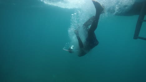 a man in snorkeling mask filming selfie video while falling off from a boat