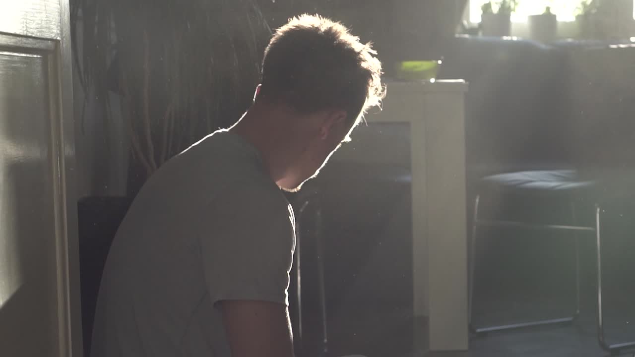 A man coughing in a dusty environment