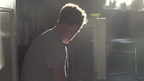 a man coughing in a dusty environment