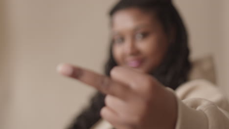 portrait of cool african woman showing middle finger