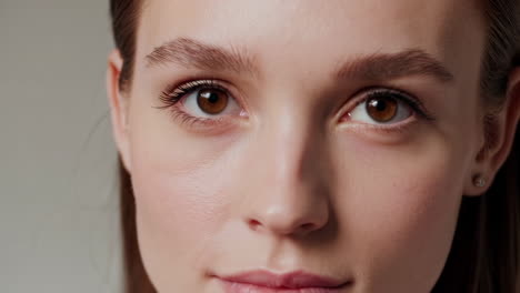close-up of a young woman's face with open and closed eyes