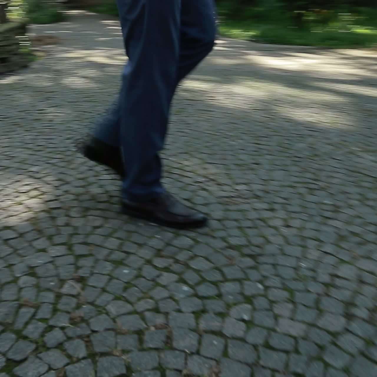 Close up of shoes and pants of a groom walking on the street. Square video